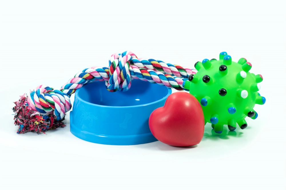 Dog toys, food bowl, and bal to fetch